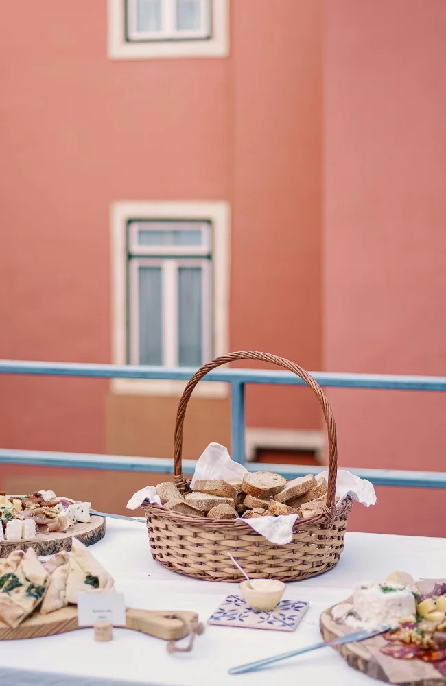 Buffet en plein air avec panier de pain, fromages et spécialités locales, illustrant les pauses gourmandes valorisant la gastronomie portugaise lors des événements Solal Events.